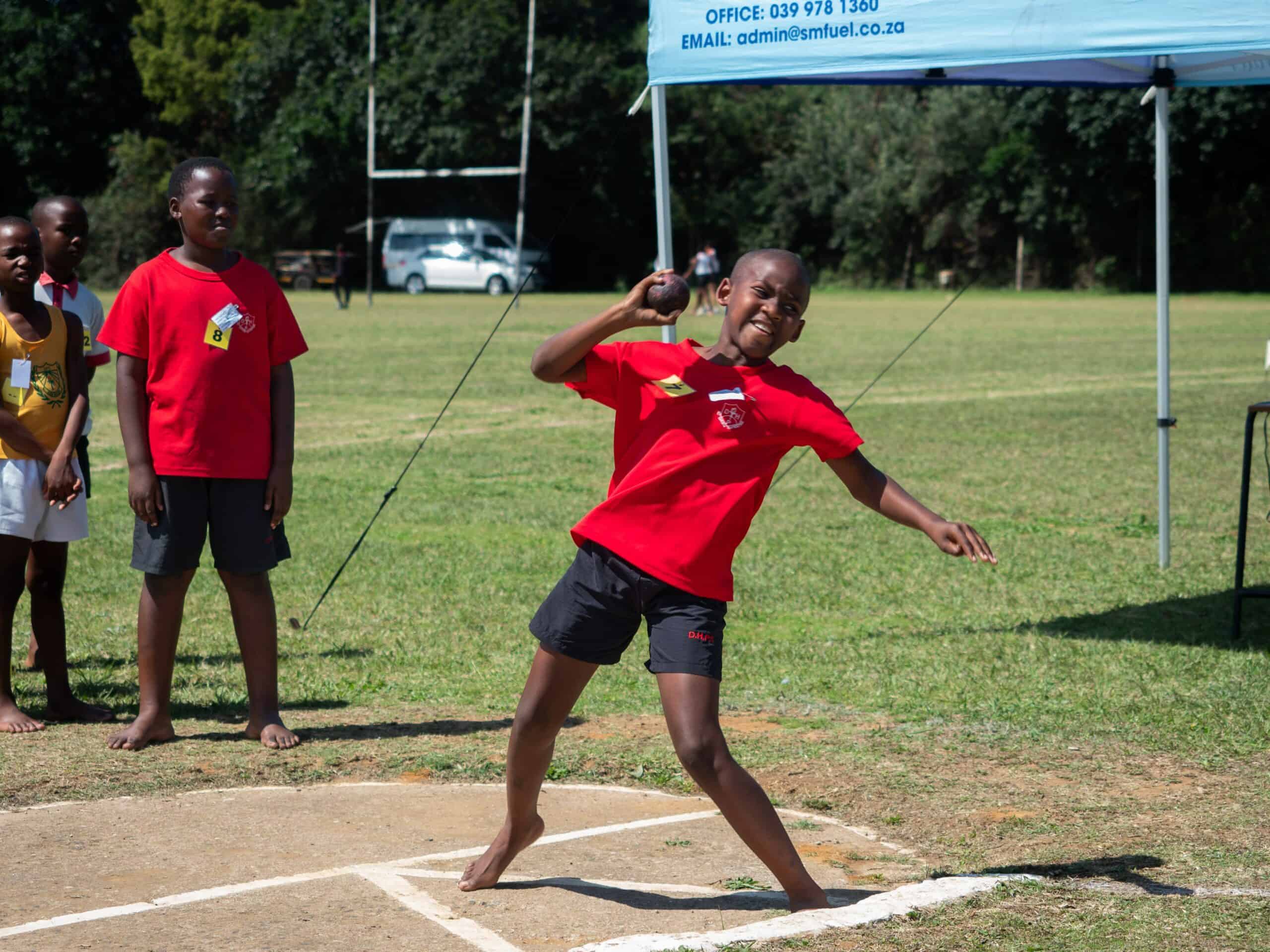 A child doing shot put.