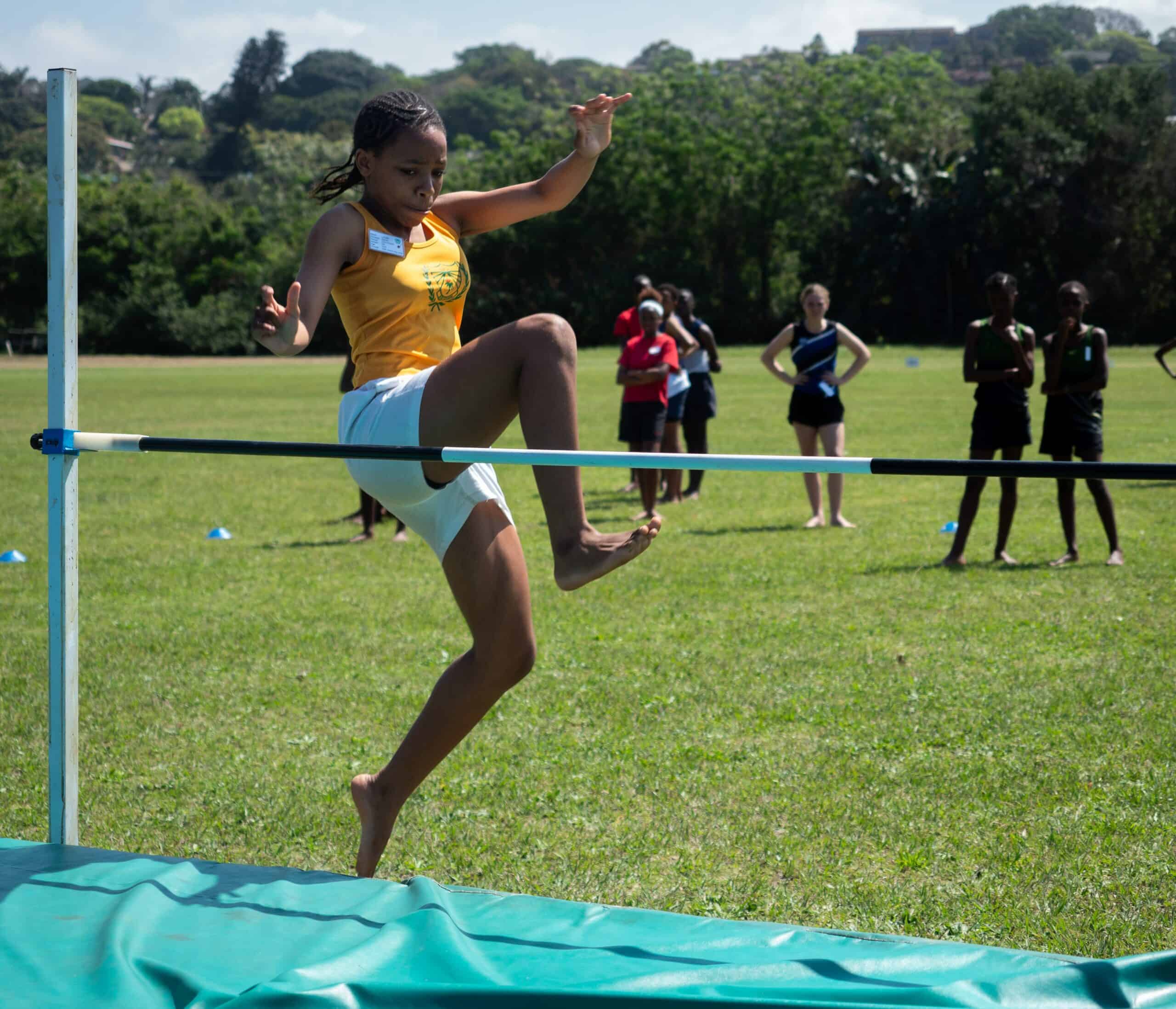 A child doing high jump.