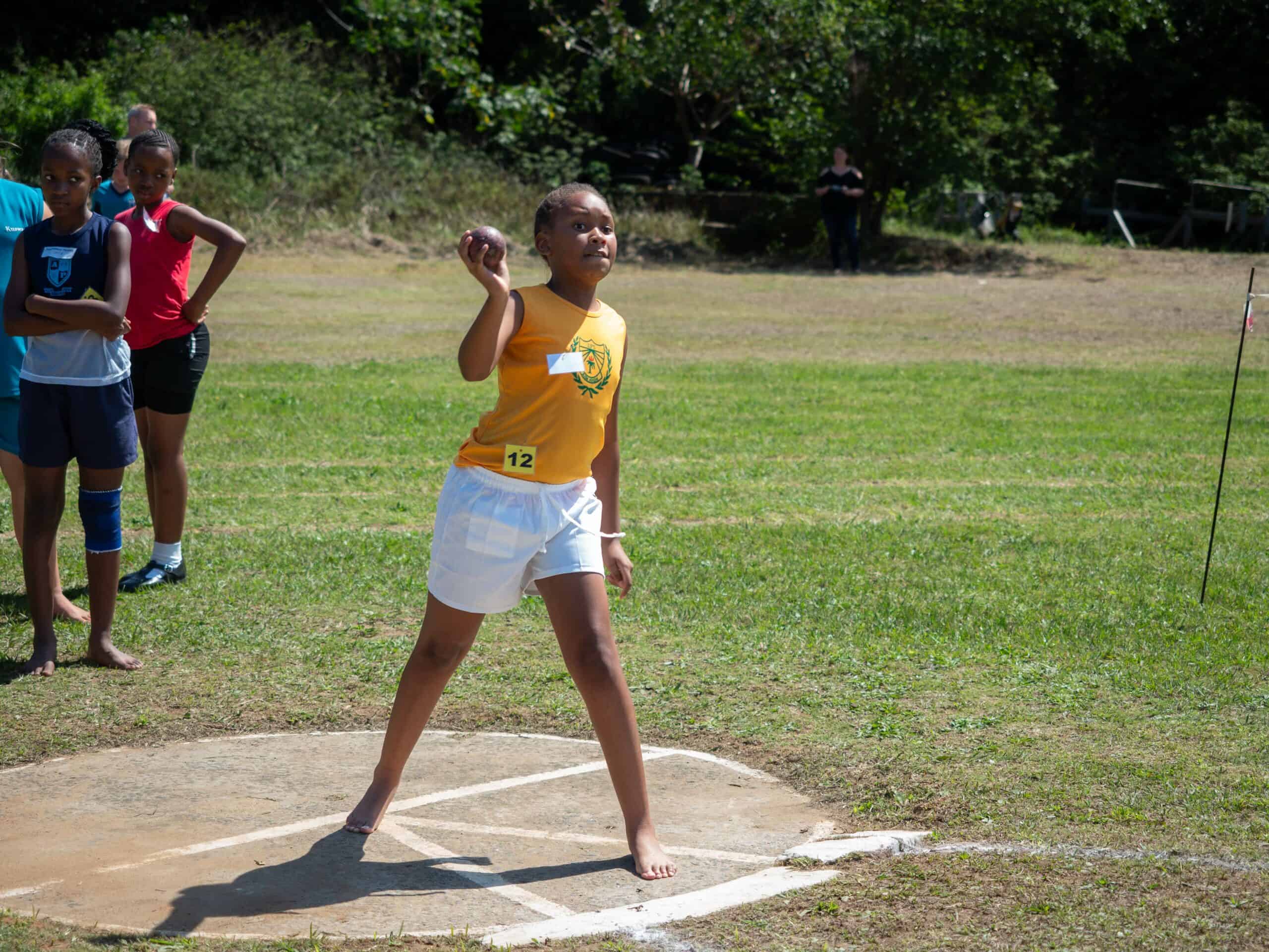 A child doing shot put.