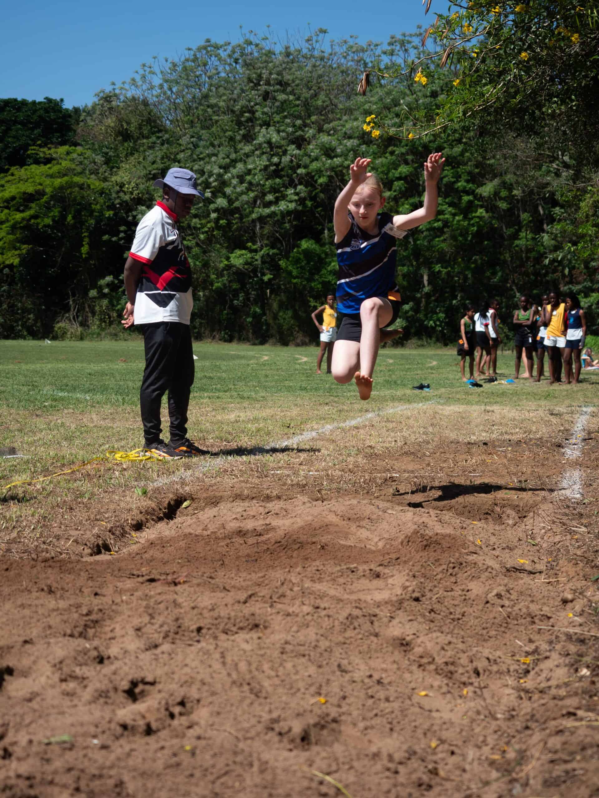 A child doing long jump.