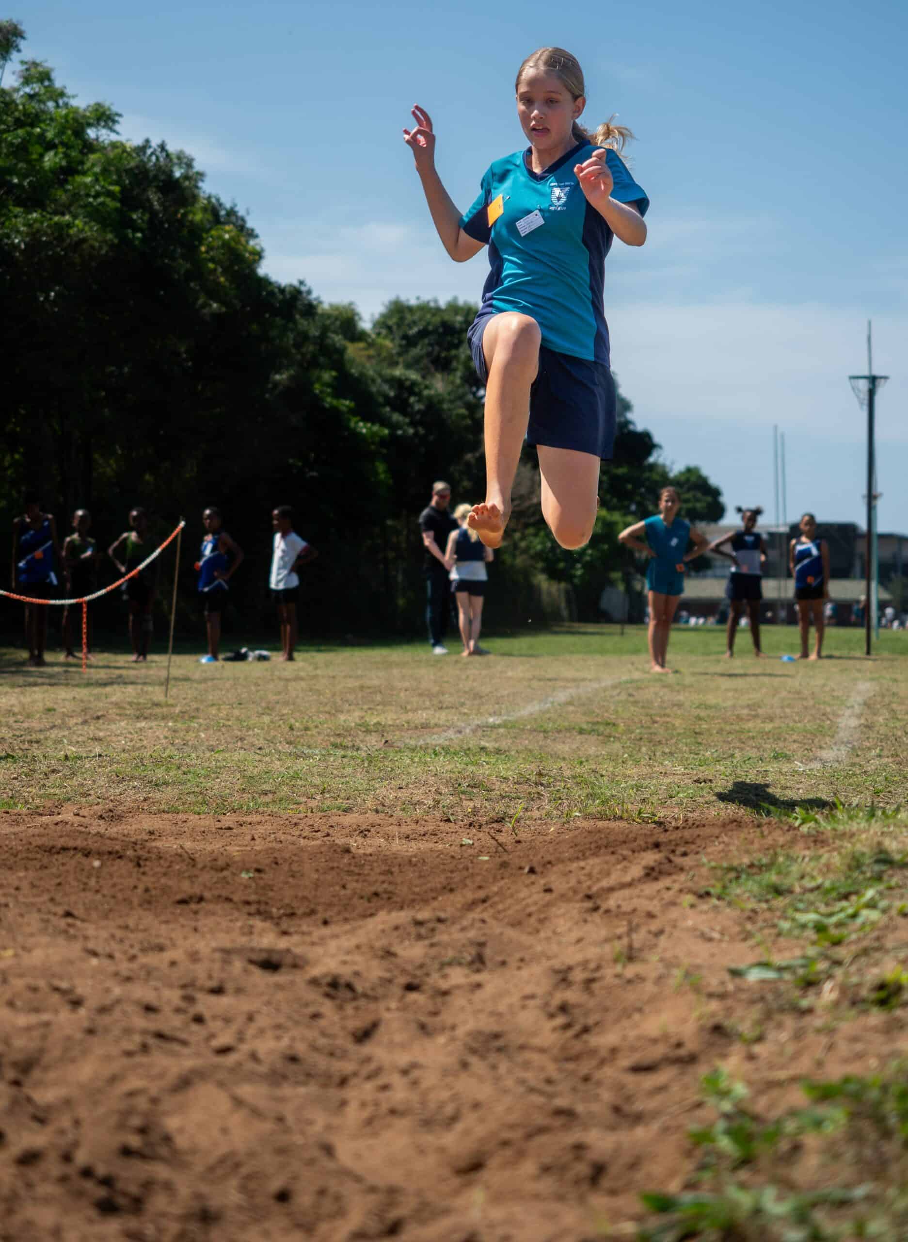 A child doing long jump.