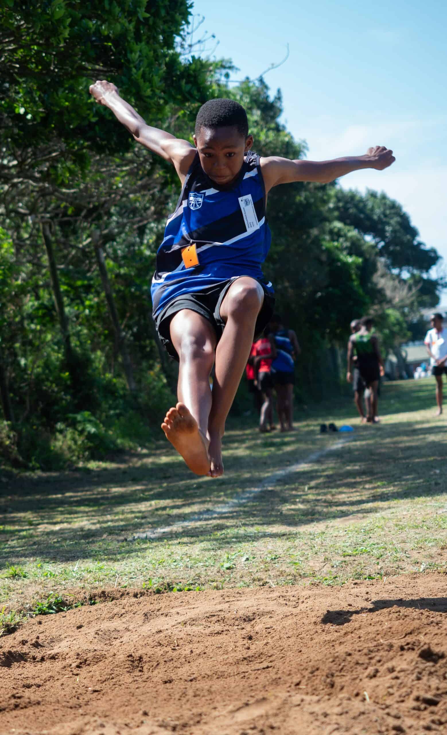 A child doing long jump.