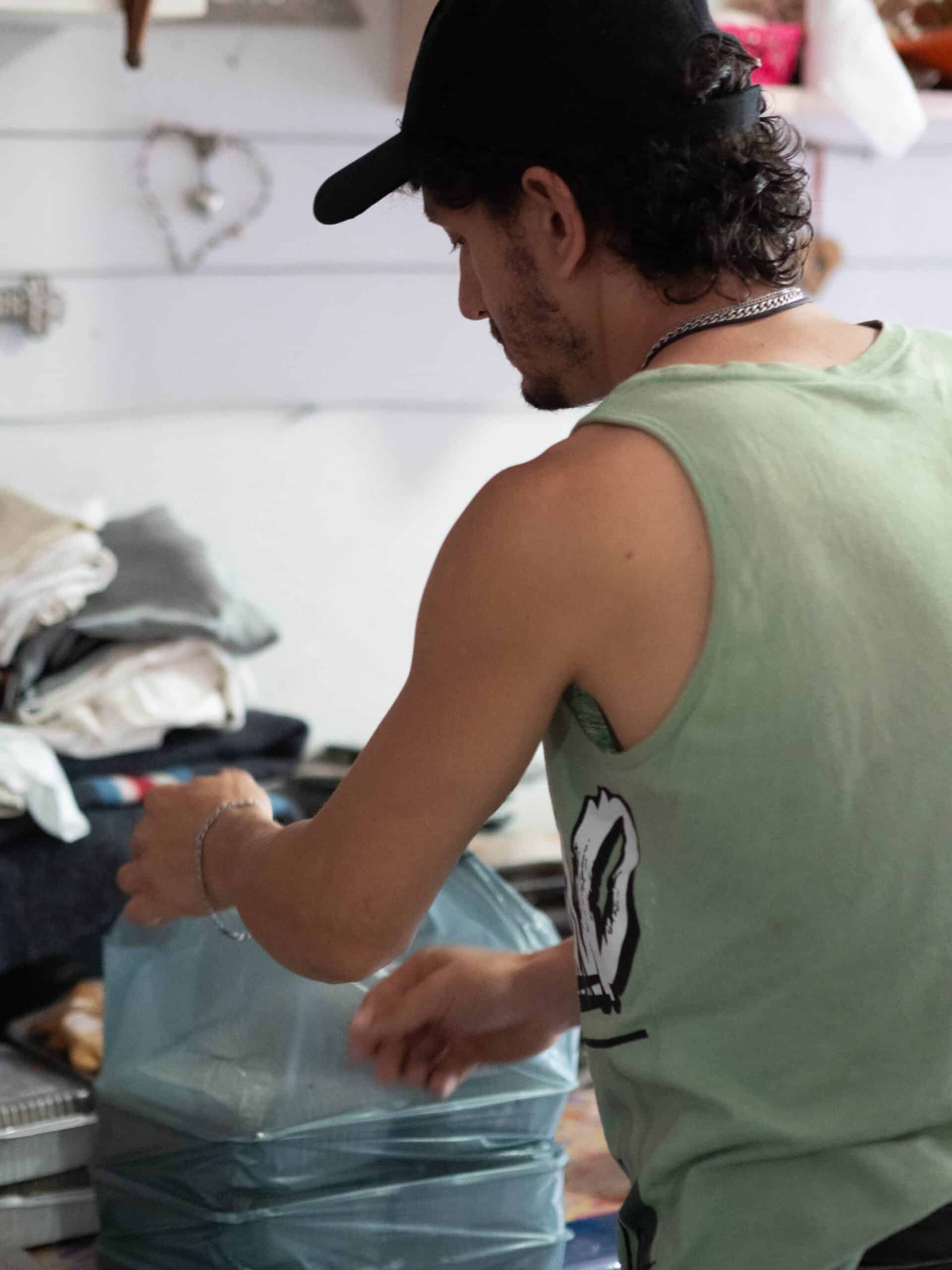 A man packing a food hamper.