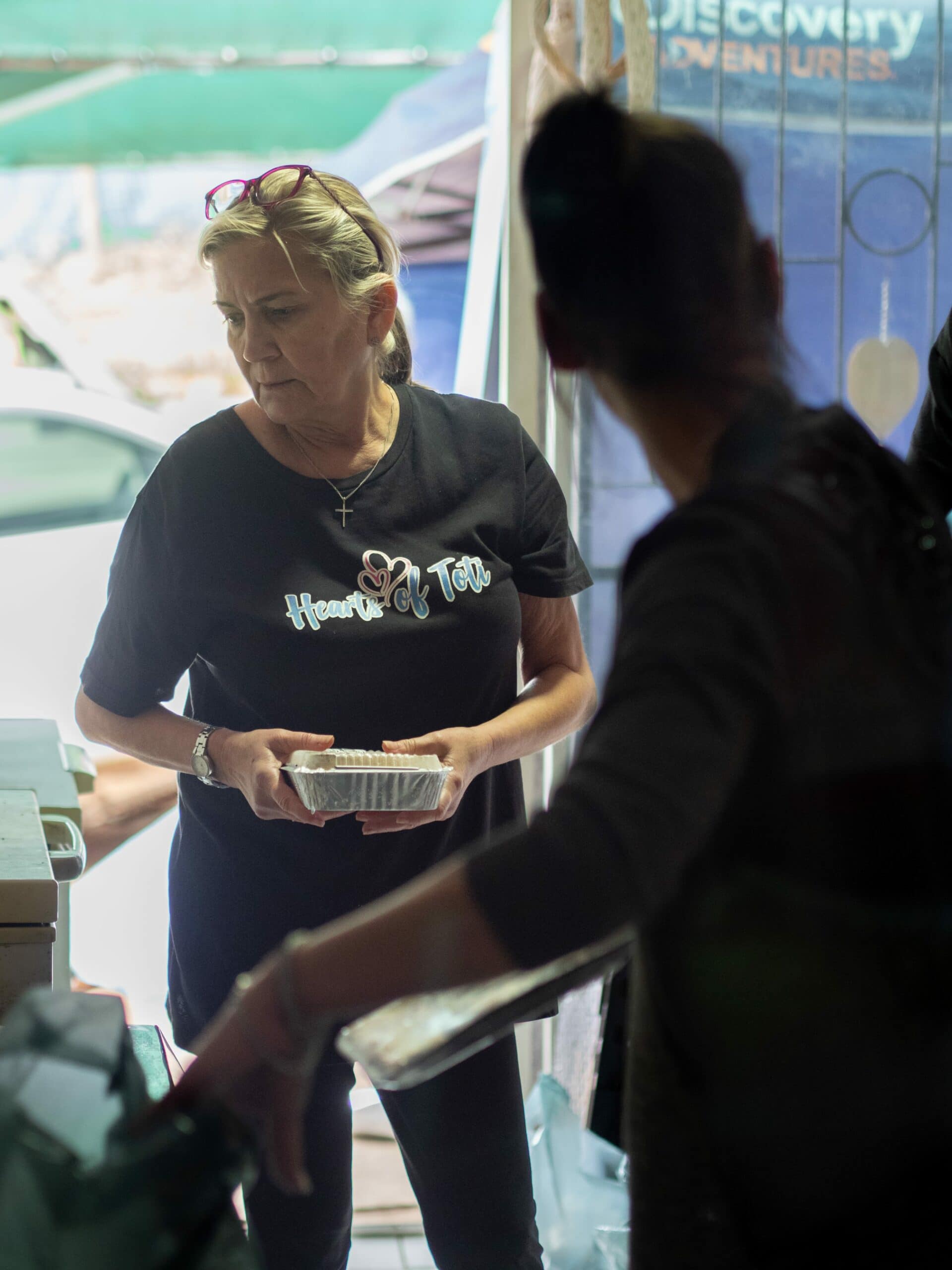 A woman holding a frozen food item.