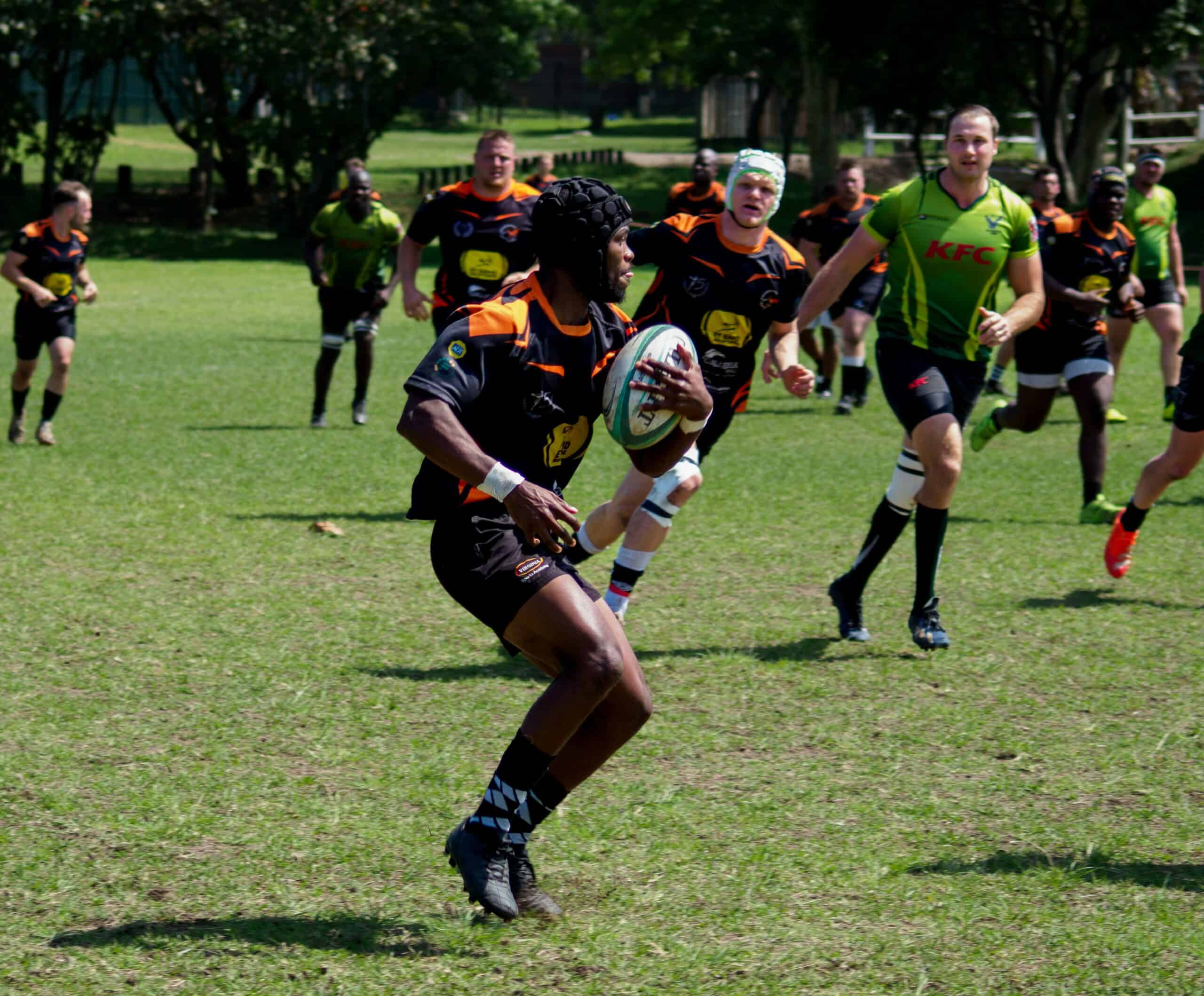 A rugby player holding the ball.