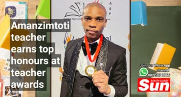 A man holding a medal.