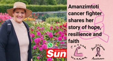 A woman with a hat in a flower garden.