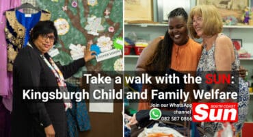 A woman pointing at a charity tree. Two women working at a store.