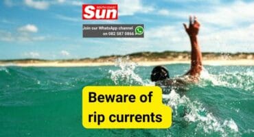 A photo of a man seemingly drowning at sea.