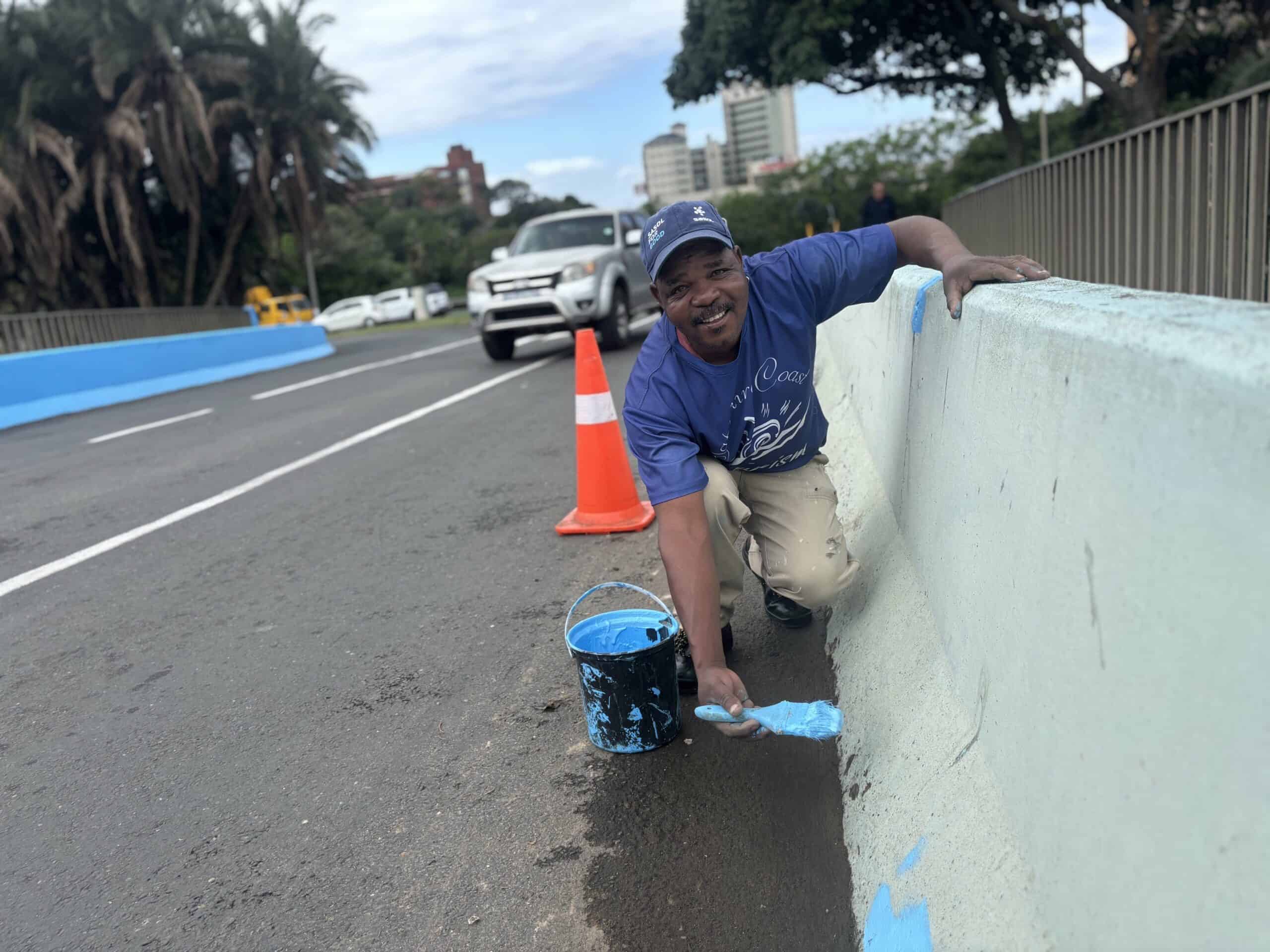 A man working on restoring a bridge. 