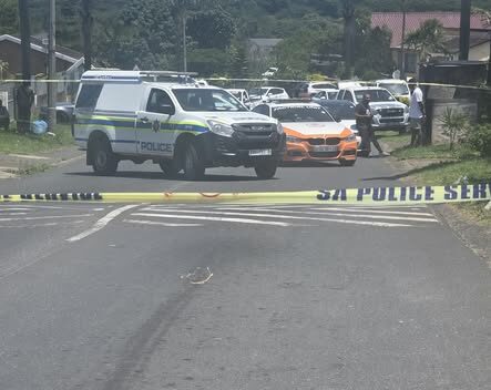 Police vehicles and ambulances in the middle of a crime scene. 