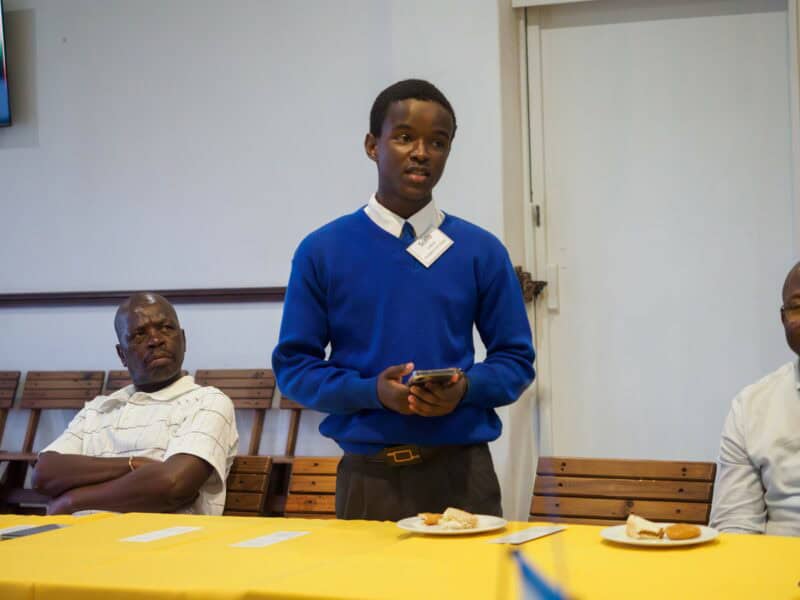 A school learner standing up, speaking.