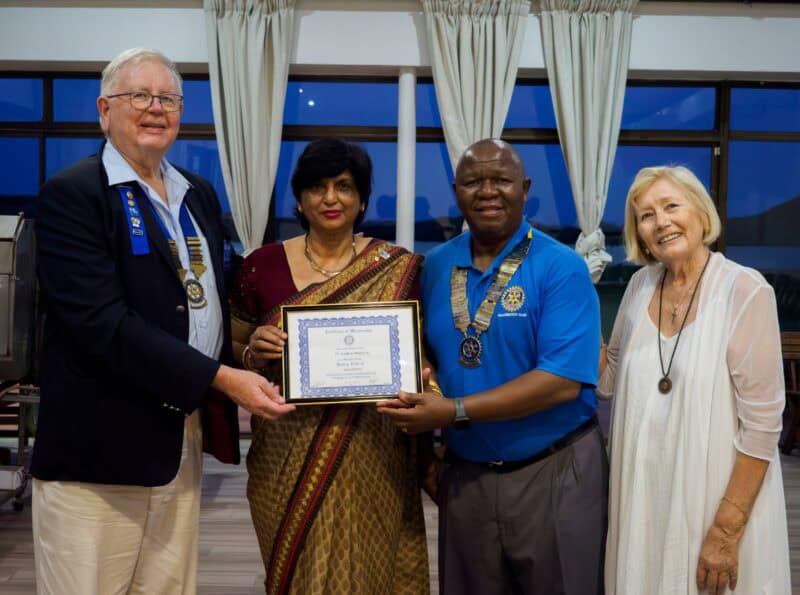 A group photograph, one woman holding a certificate.