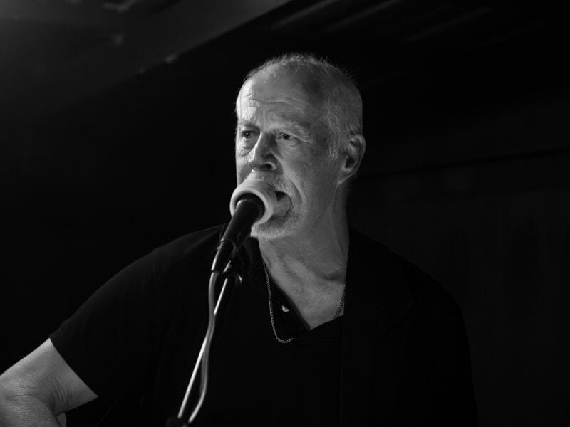 A man playing the guitar and singing.
