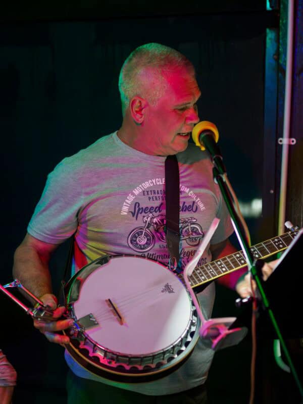 A man showing off his banjo.