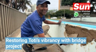 A man working on restoring a bridge.