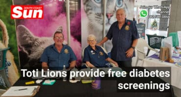 A group of people behind a desk.