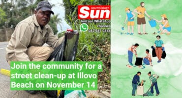 A man picking up dirt and putting it in a trash bag.