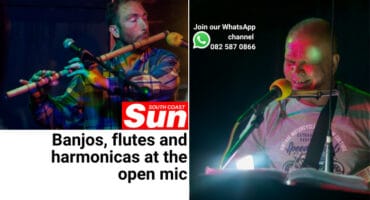 A man playing a flute, and a man playing a guitar and harmonica.