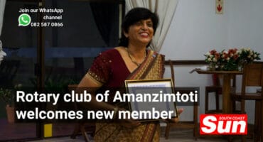 A woman holding a certificate, smiling.