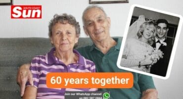 An elderly couple sitting on the couch.