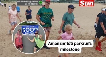 A group of people walking on beach sand
