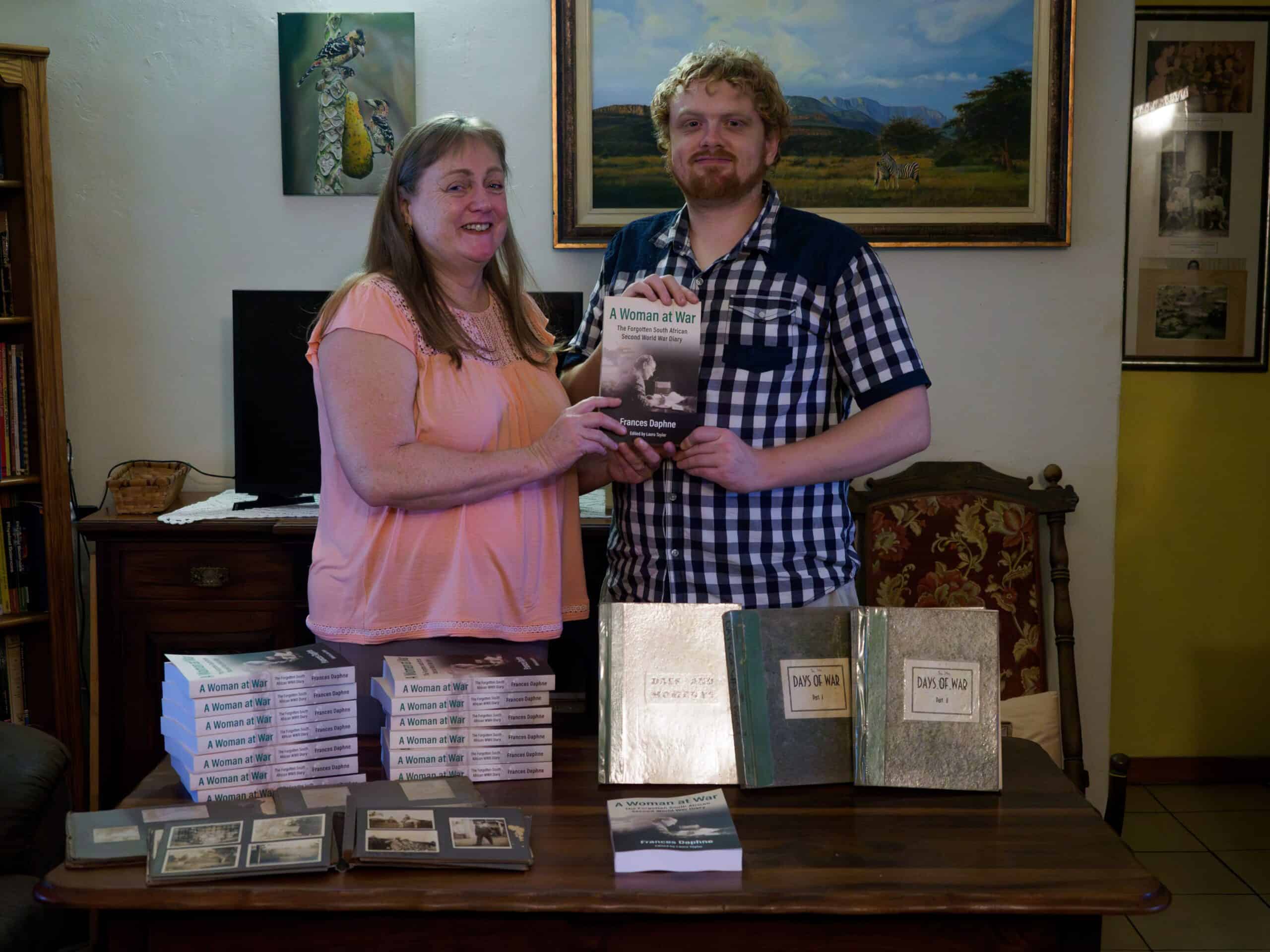 Two people, mother and son holding a book