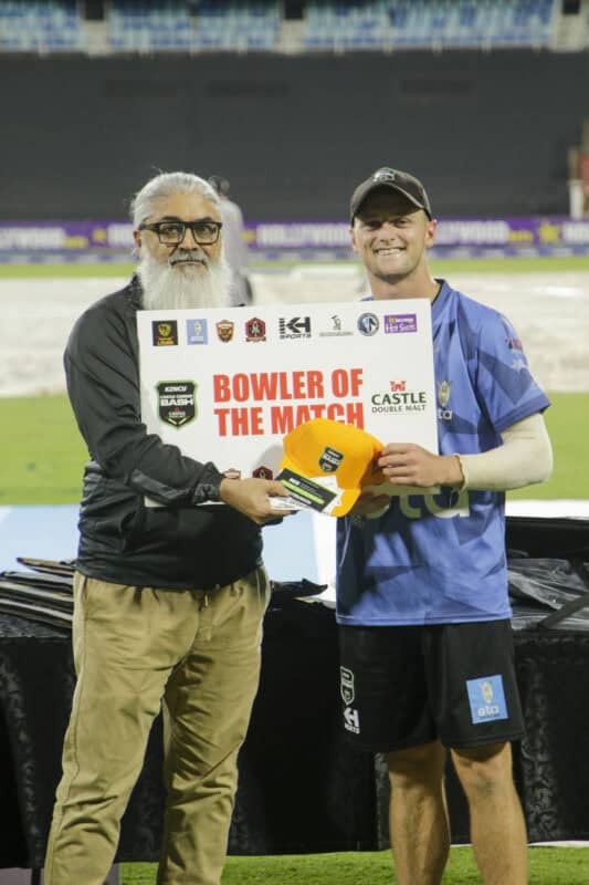 A cricketer getting an award.