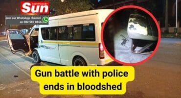 A minibus taxi at a stop next to the road with the door open.