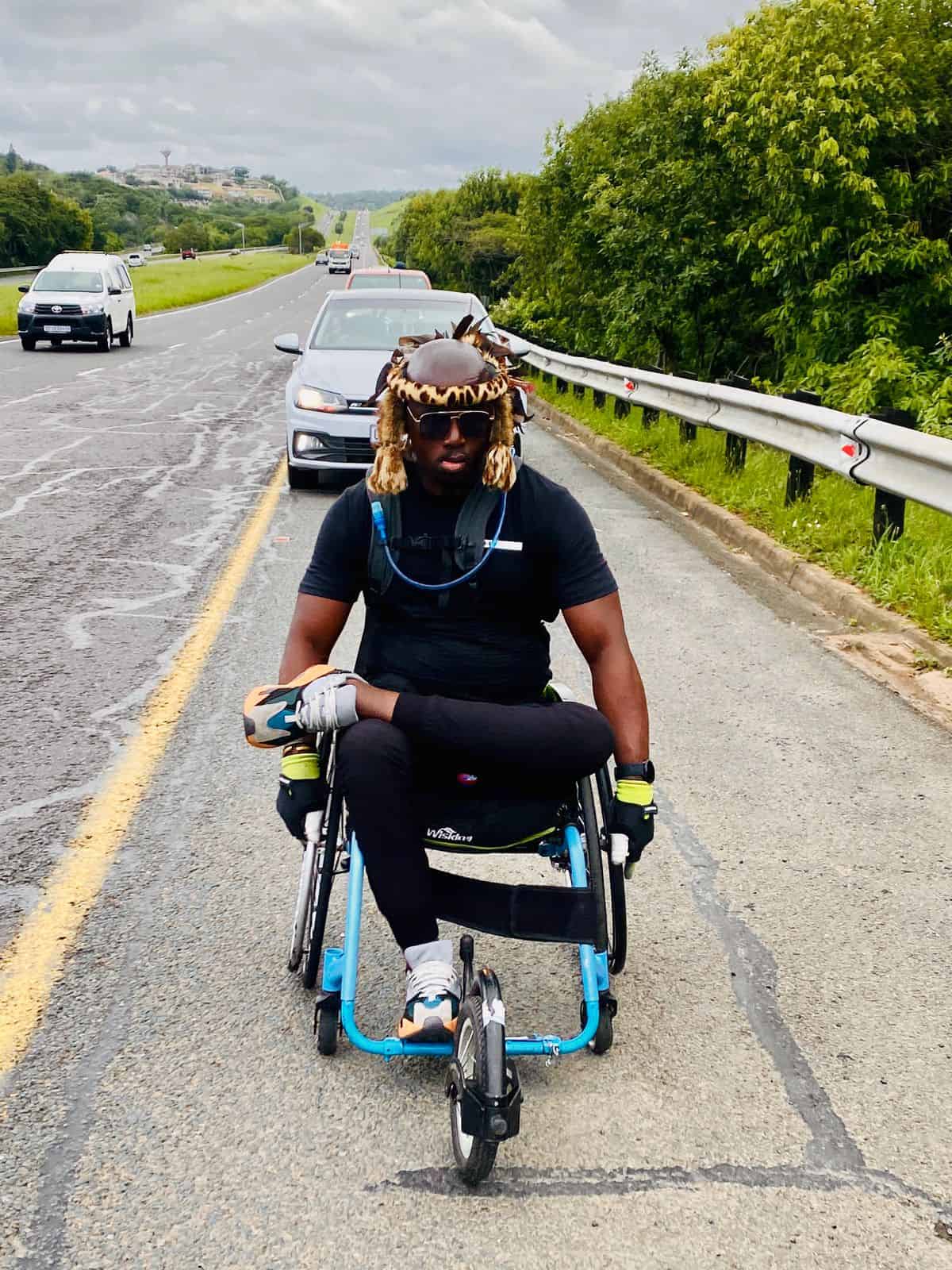 A man in a wheelchair rolling
