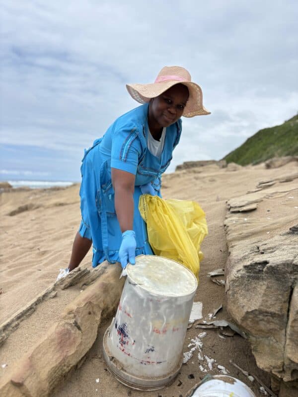A person cleaning a beach