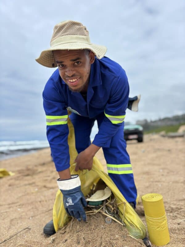 A person cleaning a beach