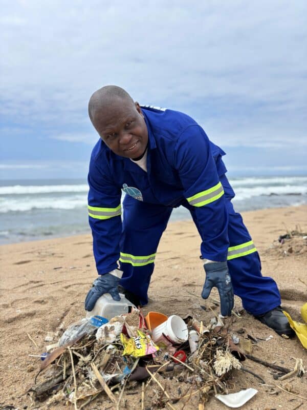 A person cleaning a beach