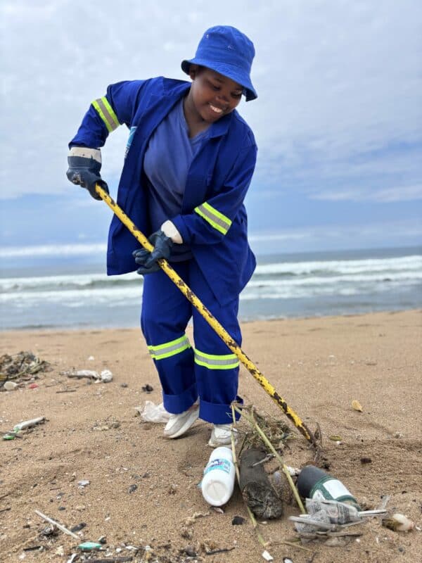 A person cleaning a beach