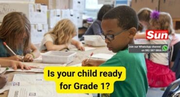 A photo showing young children in the classroom sitting on their desks.