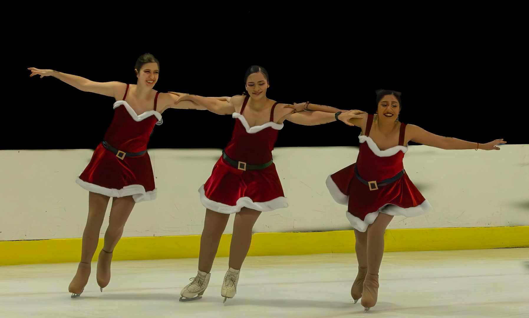 three girls ice skating