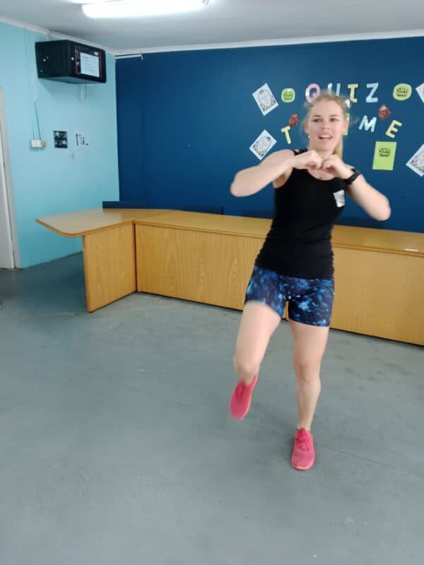 A woman demonstrating fighting stances.