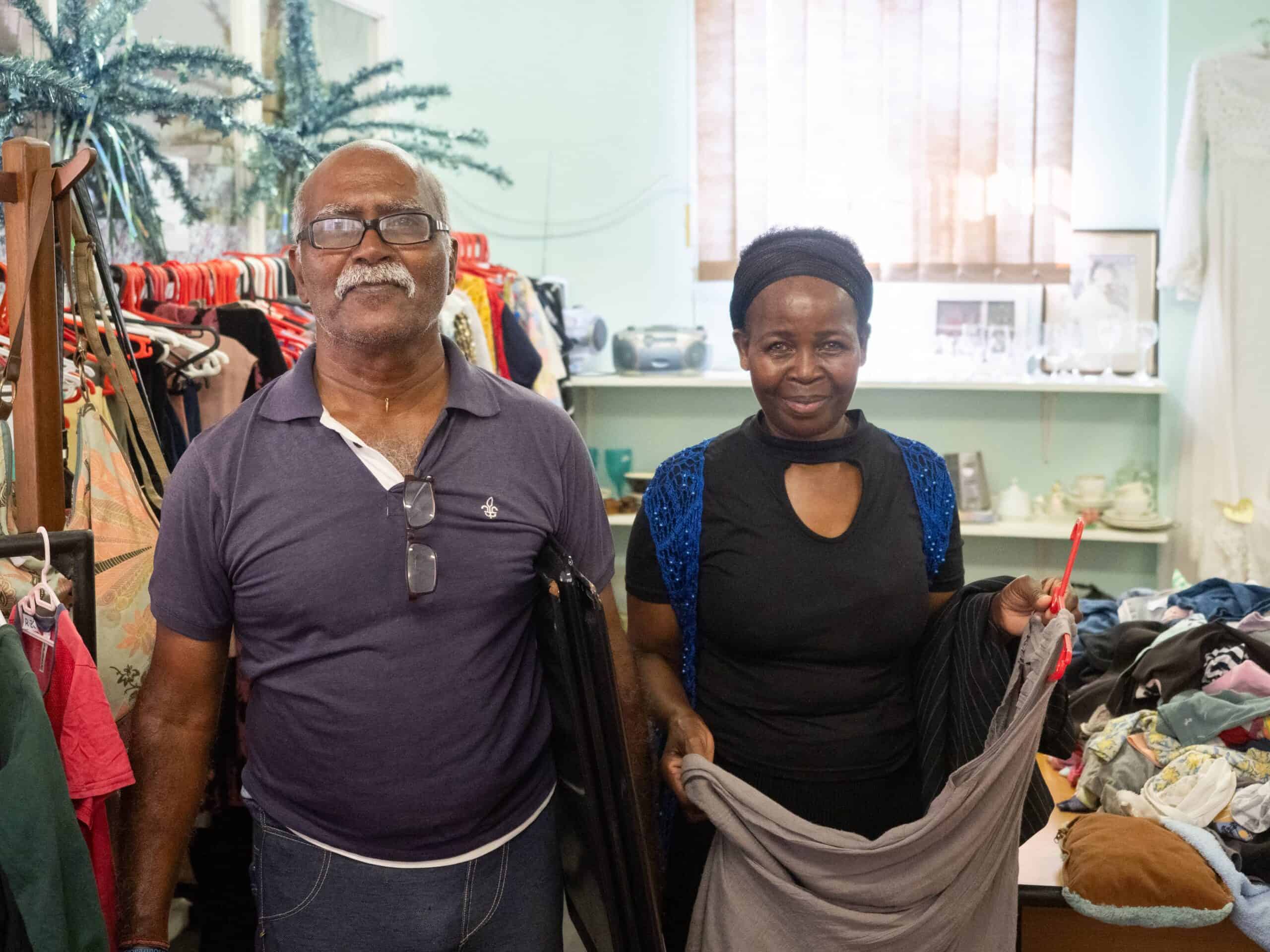 Two people shopping at a charity shop.