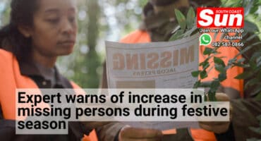 Two investigators looking at a missing persons poster.