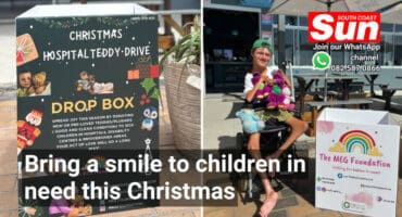 a paraplegic man in a wheelchair next to a donation box.