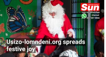 Santa Claus handing out gifts from a bag to children.