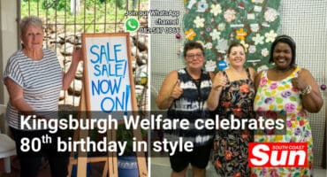 A woman next to a sale sign. Three woman in front of a tree.