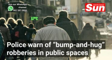 the backs of people walking along a road