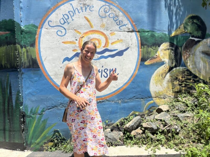 An artist stood in front of a mural