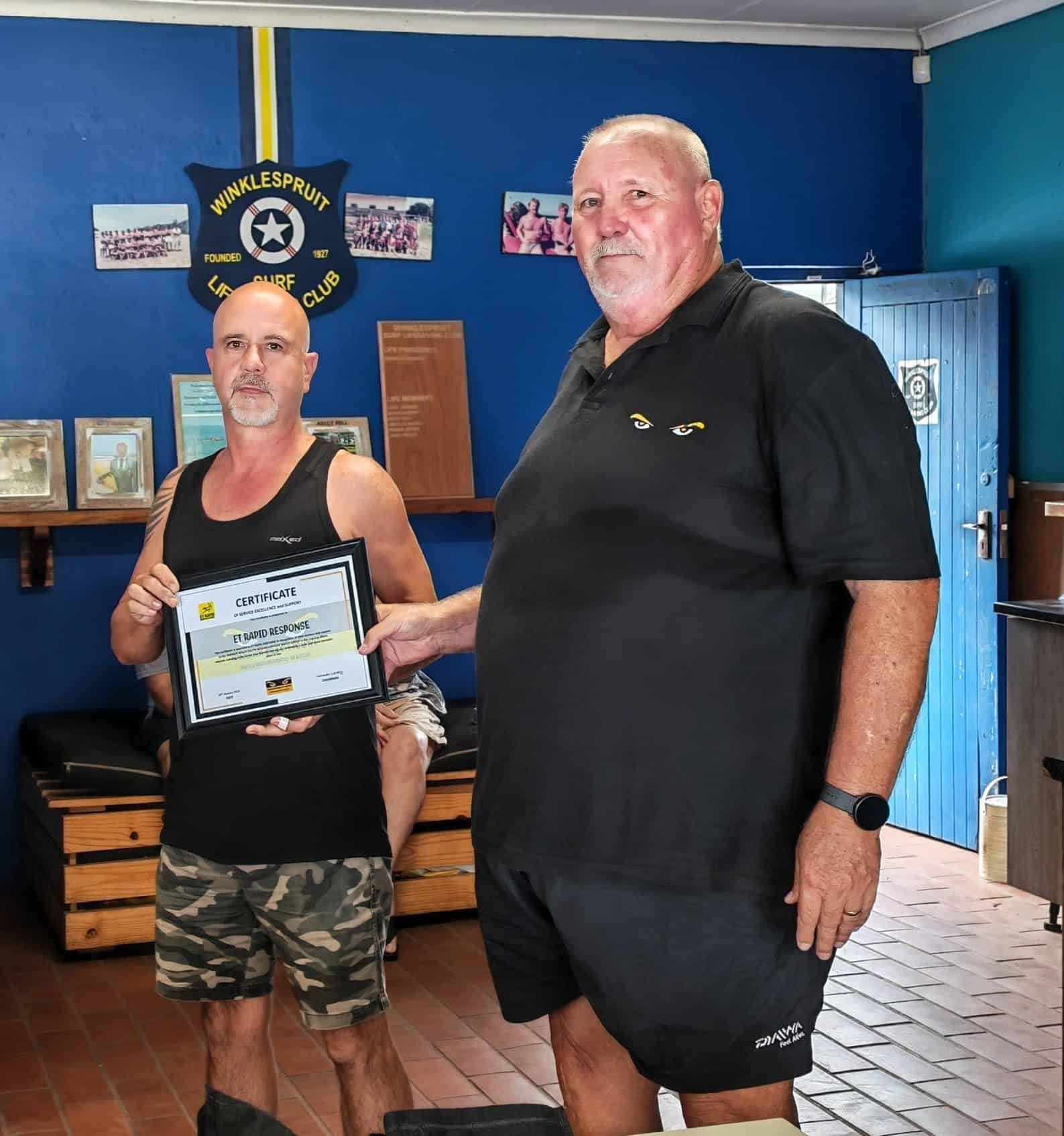 one person handing a certificate to another person