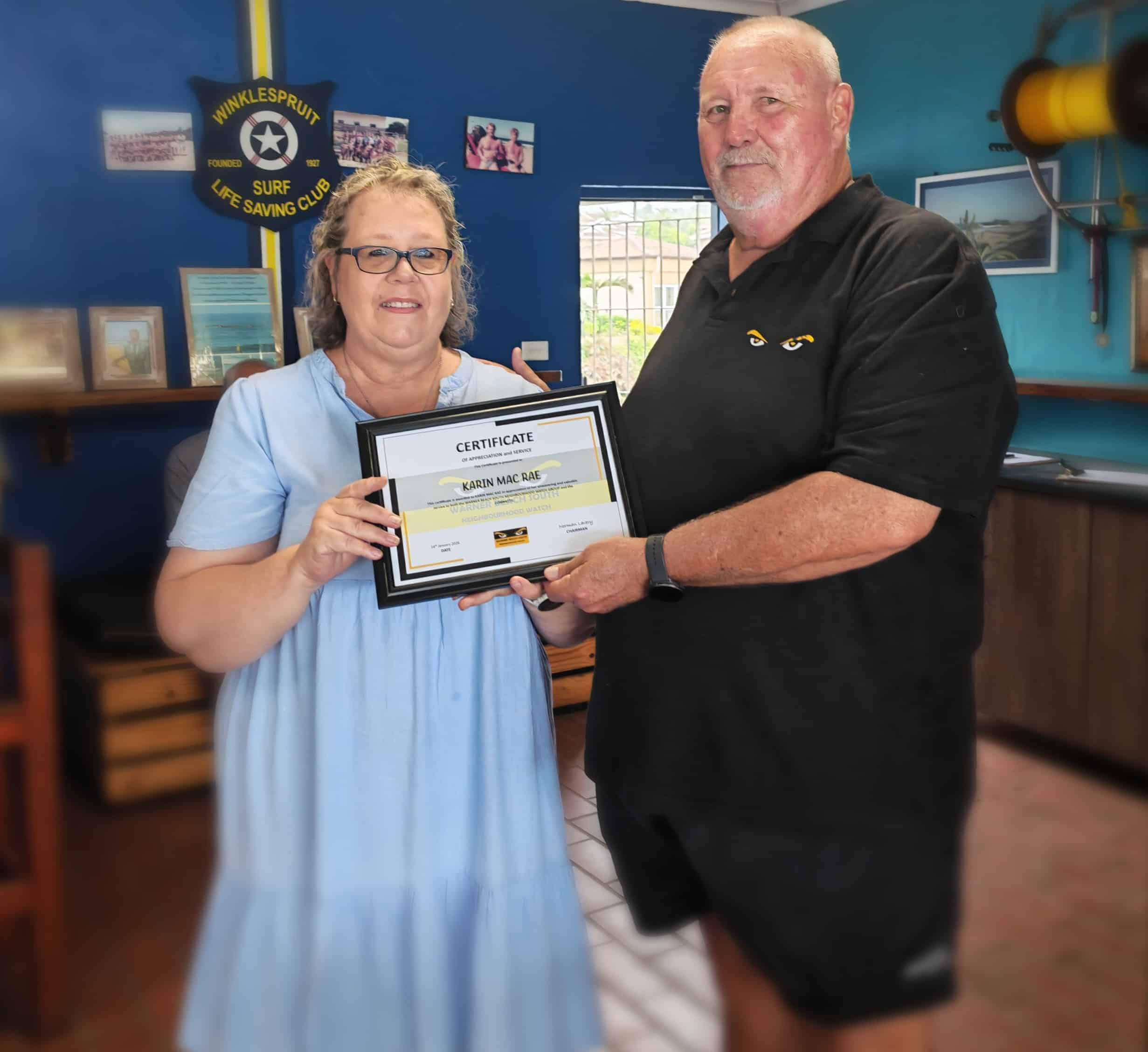 one person handing a certificate to another person
