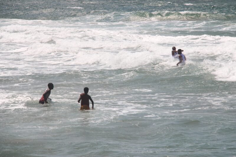 children playing and bathing in a beach