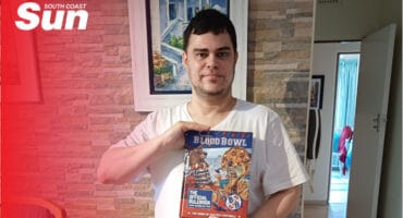 a man holding up a board game