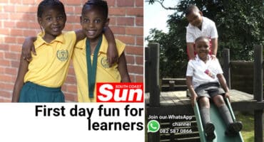 Two school children holding one another. Twins in a play area.