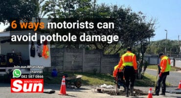A pothole repair team in action on a road.